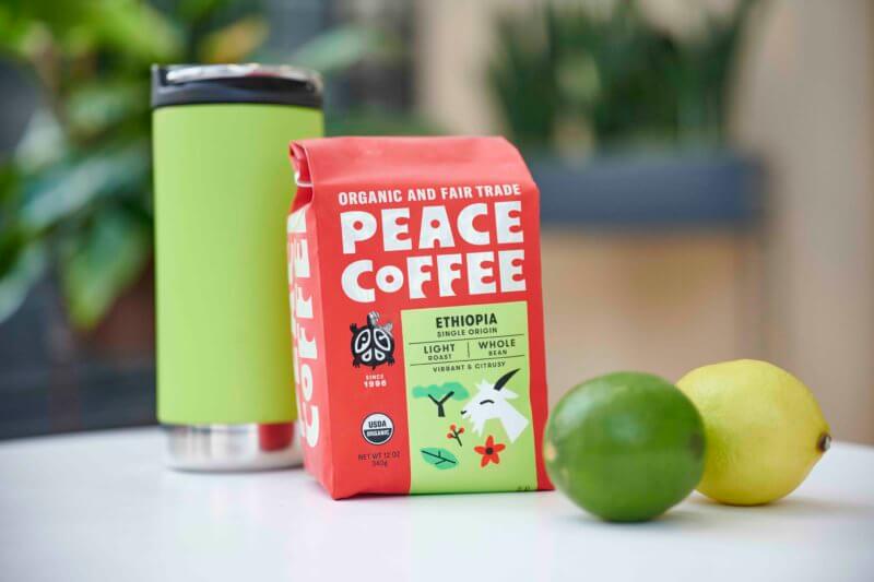a bag of ehtiopia light roast organic coffee with travel mug